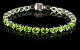 Peridot Tennis Bracelet, a line of oval cut peridots totalling 23cts,