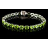 Peridot Tennis Bracelet, a line of oval cut peridots totalling 23cts,