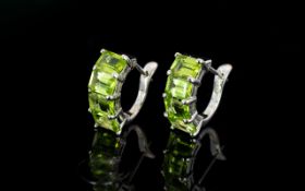 Peridot Huggie Hoop Earrings, four octagon cut peridots set to the front of each close-fitting hoop,
