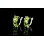 Peridot Huggie Hoop Earrings, four octagon cut peridots set to the front of each close-fitting hoop,