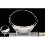 Early 20th Century Silver Footed Top Handle Bowl Of Plain form raised on four foliate form feet
