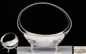 Early 20th Century Silver Footed Top Handle Bowl Of Plain form raised on four foliate form feet