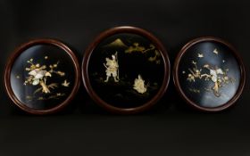 A Set Of Three Japanese Inlaid Panels Circular wall mounted panels, two depicting birds of prey on