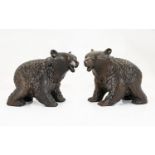 A Pair Of Black Forest Style Carved Bears Two black bears in prowling stance with glass eyes, each