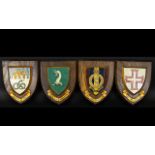 Four Wooden Heraldic Shields Each with hand painted raised shield detail to centre and gilt ribbon