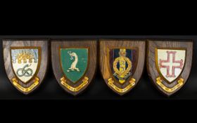 Four Wooden Heraldic Shields Each with hand painted raised shield detail to centre and gilt ribbon