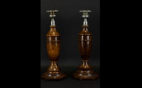 A Pair of 1920's Turned Oak Candlesticks Each with silver plated drip trays,