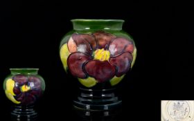 William Moorcroft Small Tubelined Urn-shaped Vase 'Clematis' on Green Ground.