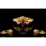 Ruby Solitaire Claddagh Ring, the traditional Claddagh style shows a 1ct heart cut ruby,