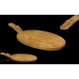 Robert Thompson Mouseman Hand Carved Oak Cheeseboard Of oval form with raised handle.
