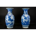 A Pair Of Chinese Antique Blue And White Vases Prunus blossom decoration throughout, unmarked base,