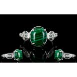 Malachite and White Topaz Ring, an oval cut cabochon of 6cts, of the naturally striated malachite,