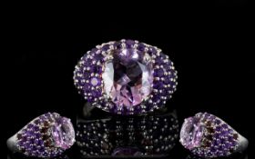 Amethyst and Rhodolite Garnet Dome Ring, an oval cut 4.5ct solitaire amethyst set above a domed