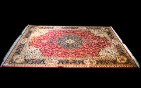 A Very Large Woven Silk Carpet Keshan rug with red ground and traditional Middle Eastern floral