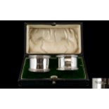 Walker and Hall Boxed Pair of Silver Napkin Holders with Celtic Pattern Banded Borders.