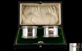 Walker and Hall Boxed Pair of Silver Napkin Holders with Celtic Pattern Banded Borders.