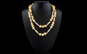 Early 20th Century Well Carved Bone Necklace with Gold Tone Circular Clasp.