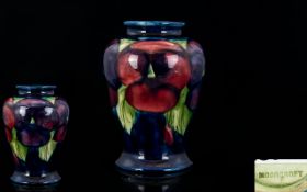 William Moorcroft Small Vase 'Pansy' on Blue Ground. Of good form, circa 1920s.