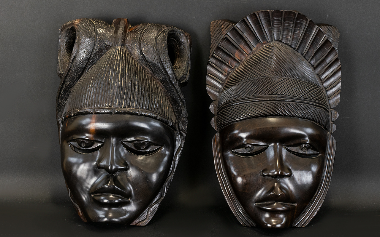 Two Carved Wood Wall Masks Ebonised wood