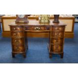 A Serpentine Fronted Pedestal Desk Comprising central drawer between two banks of four graduating