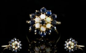 A 9ct Gold Cluster Ring Set with central sapphire surrounded by six opals,