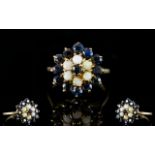 A 9ct Gold Cluster Ring Set with central sapphire surrounded by six opals,