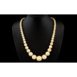 Antique Period Nice Quality Carved Ivory Beaded Necklace in Graduated Form. Age related patina.