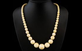 Antique Period Nice Quality Carved Ivory Beaded Necklace in Graduated Form. Age related patina.