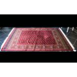 A Large Woven Silk Bokhara Carpet Ornate silk carpet with traditional lozenge and geometric repeat