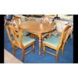 A Beechwood Dining Table And Chairs extending table of oval form with x4 accompanying fiddle back,