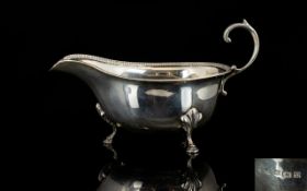 Silver Sauce Boat Of typical, plain form with egg and dart border, hoof feet with acanthus mask.