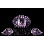 Amethyst and Rhodolite Garnet Dome Ring, an oval cut 4.5ct solitaire amethyst set above a domed