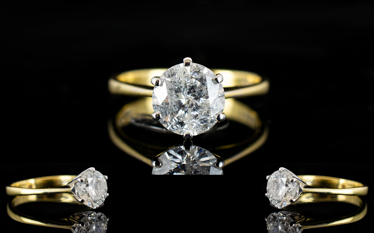 An 18ct Gold Single Stone Diamond Ring Set with a round modern brilliant cut diamond in six claw