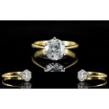An 18ct Gold Single Stone Diamond Ring Set with a round modern brilliant cut diamond in six claw