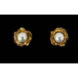 A Pair Of 9ct Gold And Faux Pearl Set Earrings Stud earrings in the form of stylised flowers, each