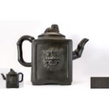 Oriental Yixing Teapot Of Square form with lion masks to body and bamboo form handle and spout.