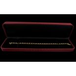 A 14 ct Diamond Tennis Bracelet Set with alternating rubies and brilliant cut diamonds,