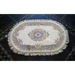 Oval Wool Rug Cream ground with grey, blue, green, pink and taupe floral and foliate border detail,