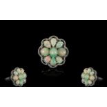 Opal Cluster Ring, comprising six pear cut and two round cut opal cabochons, closely set around an
