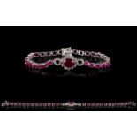 Ruby and White Topaz Accent Bracelet, the central motif comprising a 3.75ct oval cut ruby accented