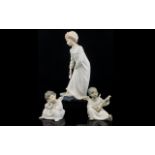 Lladro A Pair Of Cherub Figures The first in pensive pose, the second, playing a lute. Along with