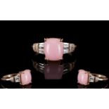 Pink Opal and White Topaz Ring, a 3ct elongated cushion cut cabochon of Peruvian pink opal,