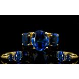 Ceylon Blue Colour Quartz Trilogy Ring, the large centre oval cut stone measuring 5.