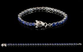 Sapphire Tennis Bracelet with Leopard Head Clasp, 15cts of oval cut blue sapphires in a single line,