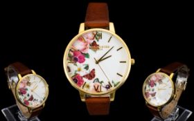 Olivia Burton 'English Garden' Tan And Gold Tone Watch Statement watch with oversized dial,