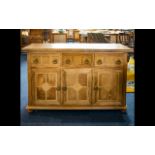 A Contemporary Mixed Wood 3 door, 3 drawer sideboard, raised on bun feet, Height 34 inches,