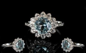 Sky Blue Topaz and White Topaz Halo Ring, a 3.5ct round cut sky blue topaz framed by .