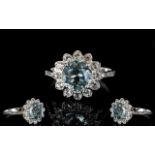 Sky Blue Topaz and White Topaz Halo Ring, a 3.5ct round cut sky blue topaz framed by .