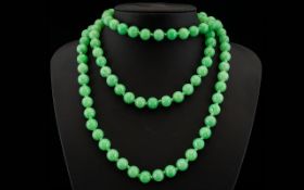 A Early 20th Century Long Strand Jadeite Bead Necklace Each spherical bead approx 10 mm,