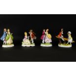 Sitzendorf Style Figures, each raised on oval bases,